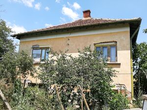 Old rural house with barn and land located in a big village